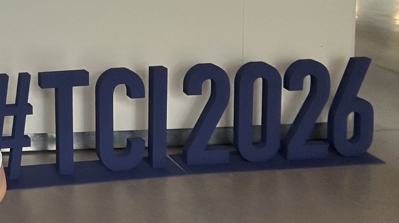 The #TCI2026 letters in the conference hall, almost empty